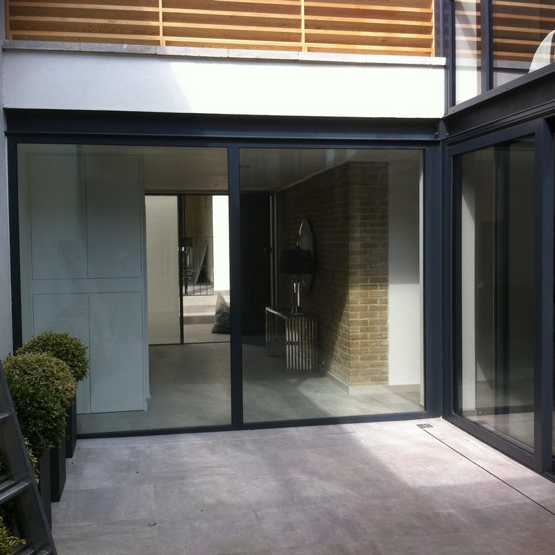 Floor-to-ceiling sliding doors opening to courtyard in Windsor