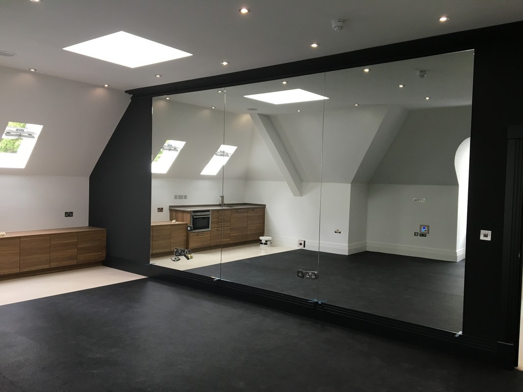 Frameless glass wall dividing loft conversion in Windsor